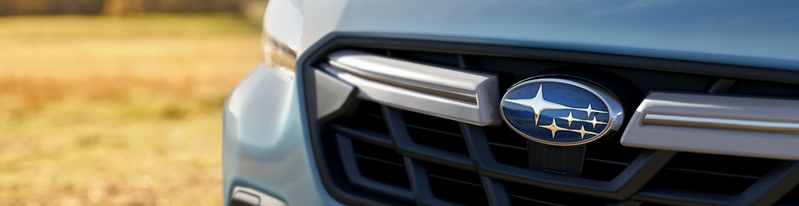 Closeup of Subaru emblem and grille.